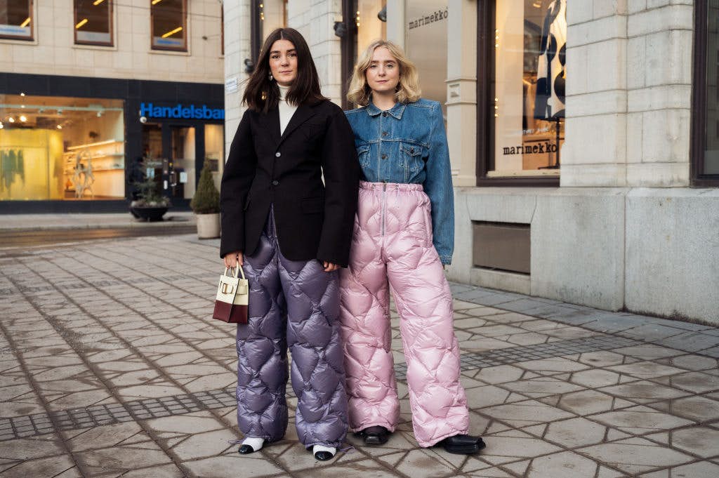 STOCKHOLM, SWEDEN - FEBRUARY 08: Linn Eklund and Fanny Ekstrand are seen wearing purple and pink Miu Miu quilted nylon pants outside Beckmans college of design show in Stockholm fashion week Autumn/Winter 2022 on February 08, 2022 in Stockholm, Sweden. (Photo by Raimonda Kulikauskiene/Getty Images)